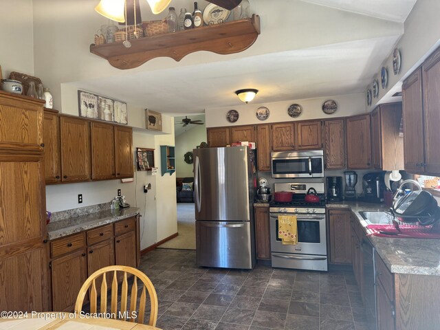 3365 Lake Of Meadows Rd, Little Meadows, PA 18830 - kitchen featuring stainless steel appliances, a ceiling fan, stone finish floors, and brown cabinets