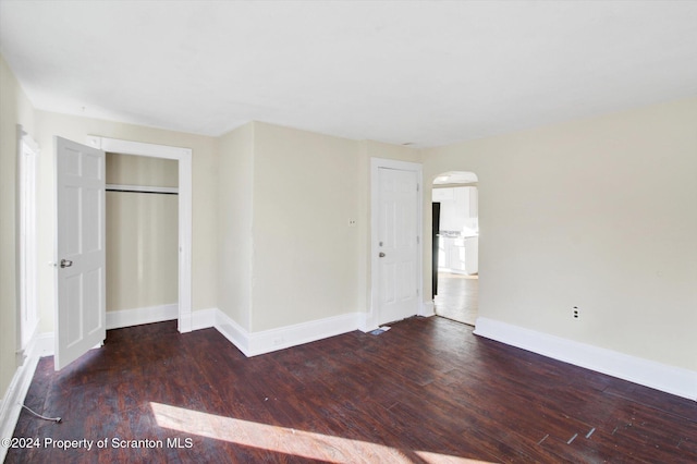 unfurnished bedroom with dark wood-type flooring