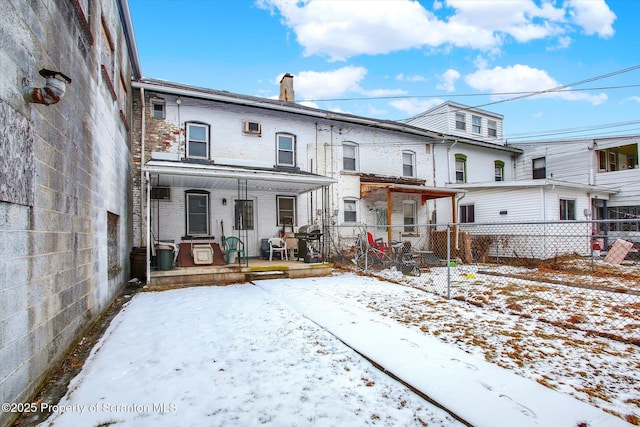 snow covered property with a porch