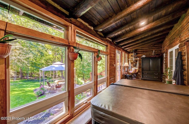 unfurnished sunroom with lofted ceiling with beams and wood ceiling