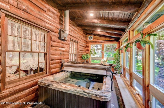 unfurnished sunroom featuring lofted ceiling with beams, a hot tub, a wealth of natural light, and wooden ceiling