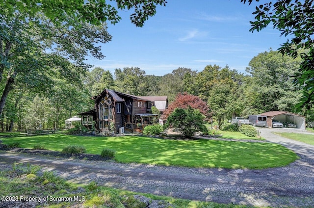 view of front of home with a front yard and a carport