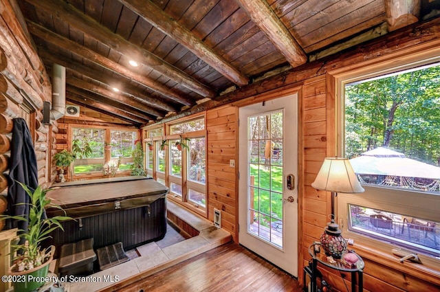 sunroom / solarium featuring lofted ceiling with beams and wooden ceiling