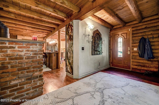 entrance foyer with beam ceiling, log walls, wooden ceiling, and wood-type flooring