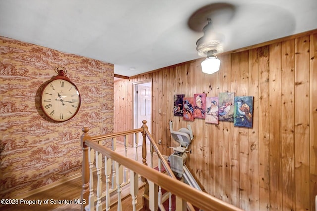 hallway with wood walls