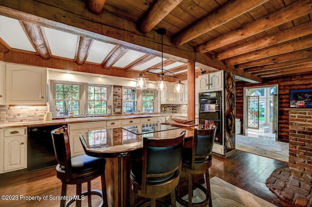 interior space with black appliances, sink, beamed ceiling, dark hardwood / wood-style flooring, and white cabinetry