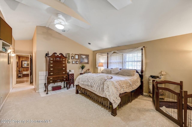 bedroom featuring light carpet and vaulted ceiling