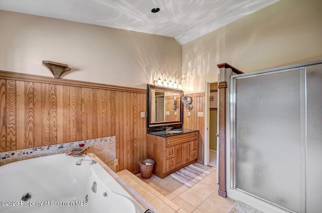 bathroom featuring tile patterned flooring, vanity, separate shower and tub, and wooden walls