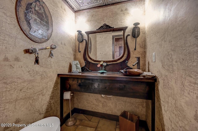 bathroom featuring tile patterned flooring, vanity, and toilet