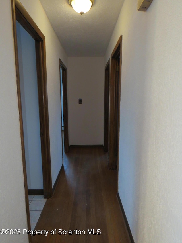 hall with hardwood / wood-style floors