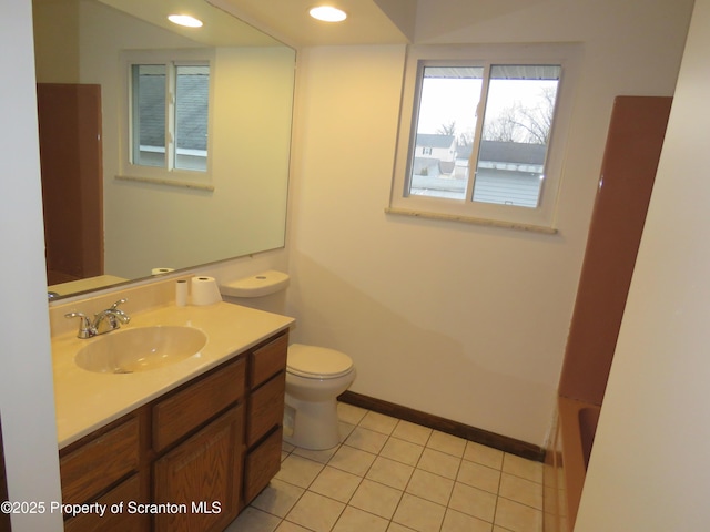 bathroom featuring vanity, tile patterned floors, a bathing tub, and toilet