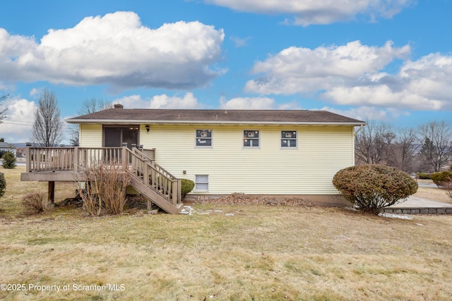 back of property featuring a yard and a deck