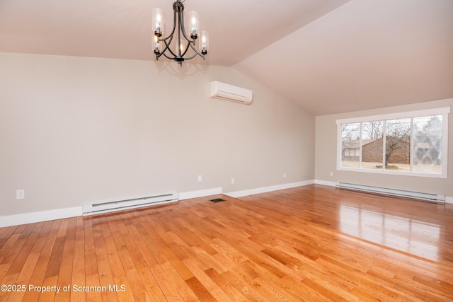 interior space featuring a baseboard radiator, vaulted ceiling, a wall mounted air conditioner, and wood-type flooring