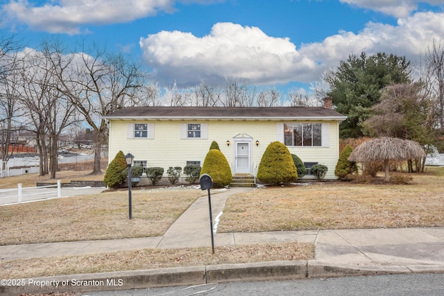 bi-level home with a front lawn