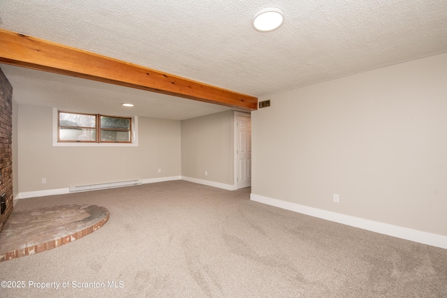 interior space with carpet flooring, a baseboard heating unit, and a textured ceiling