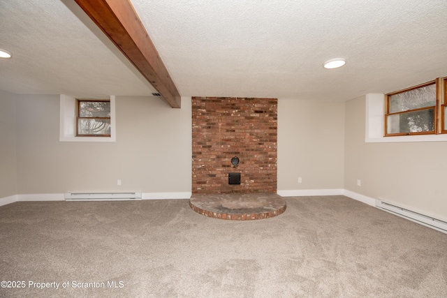 basement with a baseboard heating unit, carpet floors, and a textured ceiling