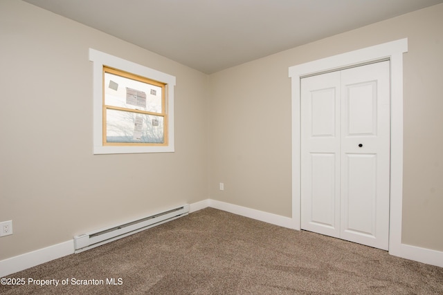 unfurnished bedroom featuring carpet flooring, a baseboard heating unit, and a closet