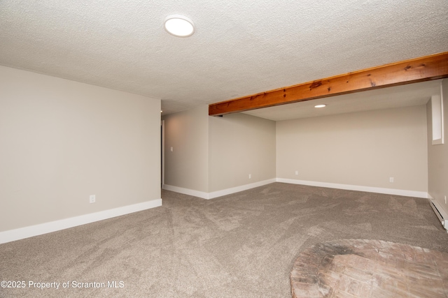 spare room featuring carpet floors and a textured ceiling