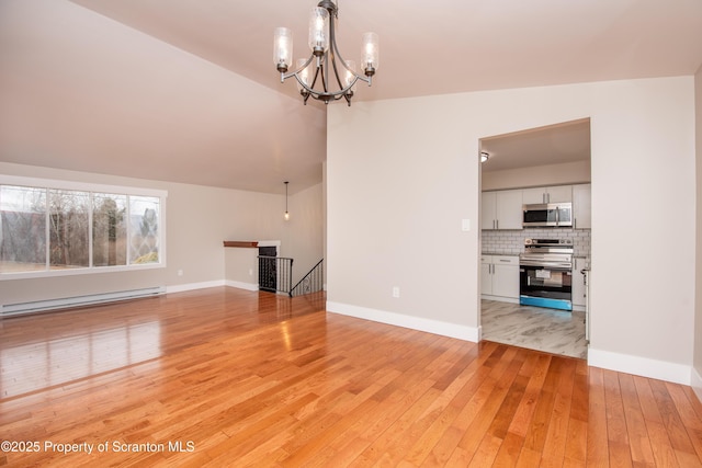 unfurnished living room featuring a notable chandelier, light wood-type flooring, vaulted ceiling, and a baseboard radiator