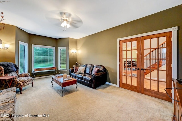 carpeted living room featuring french doors and ceiling fan