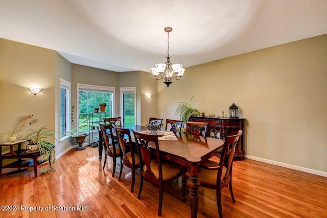 dining room featuring light hardwood / wood-style floors and a notable chandelier