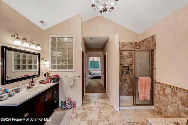 bathroom with vanity, an inviting chandelier, an enclosed shower, and vaulted ceiling