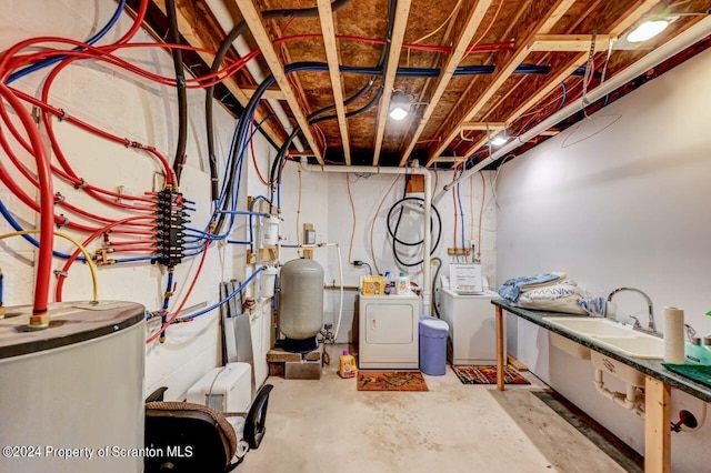 basement with sink, washing machine and dryer, and water heater