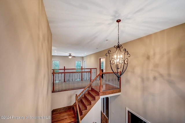 stairway with ceiling fan with notable chandelier