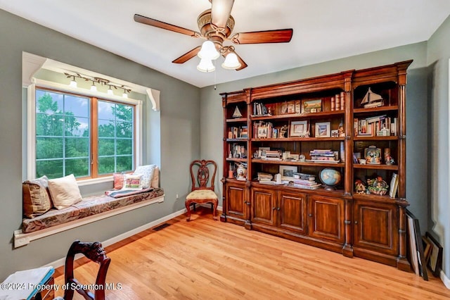 sitting room featuring ceiling fan and light hardwood / wood-style flooring