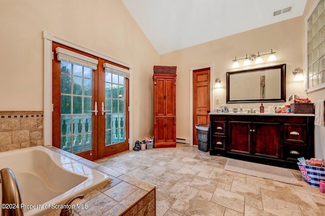 bathroom with a tub, french doors, vanity, and a baseboard radiator