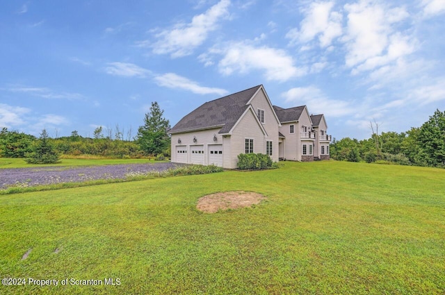 view of side of home featuring a garage and a yard