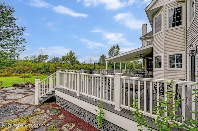 wooden terrace featuring ceiling fan and a patio