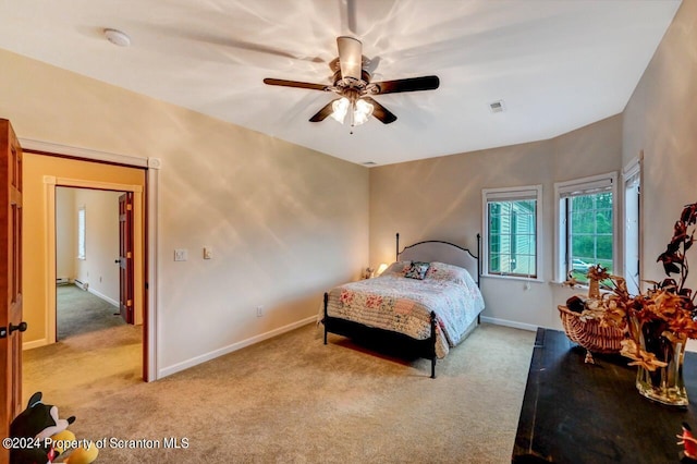 bedroom with ceiling fan and light carpet