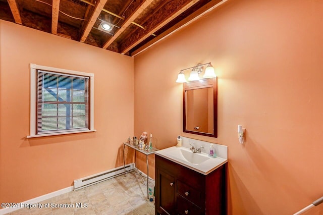 bathroom featuring baseboard heating and vanity