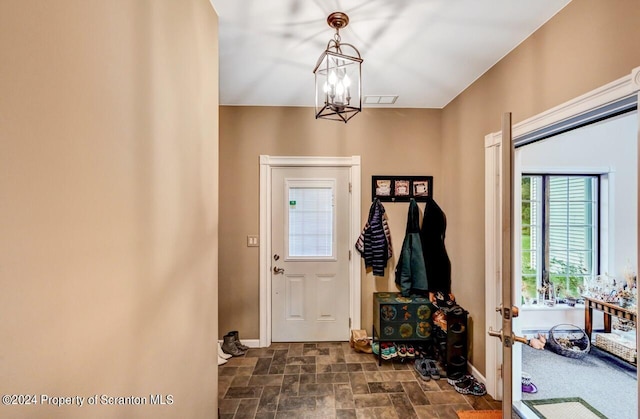 foyer entrance featuring an inviting chandelier