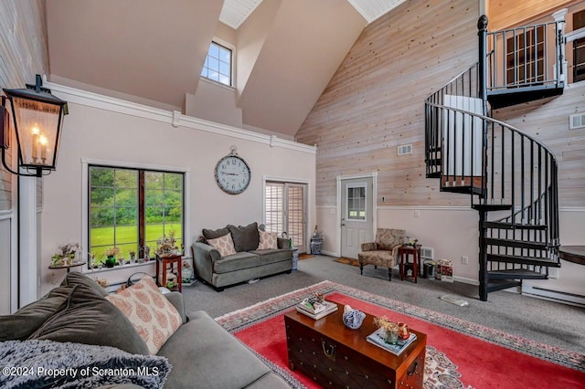 living room with wood walls, carpet, and a high ceiling