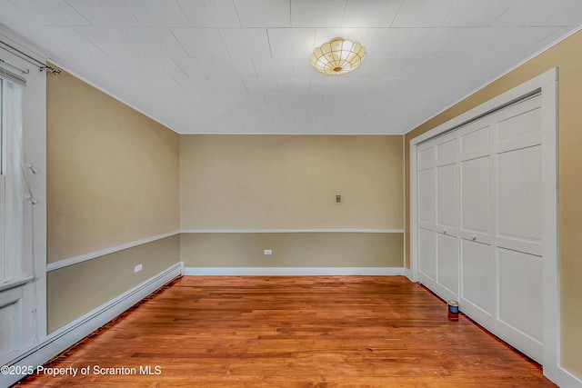11 Manzer Rd, New Milford, PA 18834 - unfurnished bedroom with a baseboard radiator, wood finished floors, and a closet