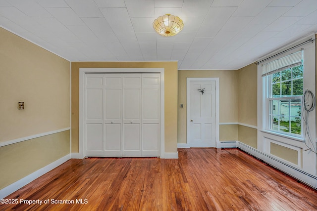 11 Manzer Rd, New Milford, PA 18834 - unfurnished bedroom featuring baseboard heating, wood-type flooring, and a closet