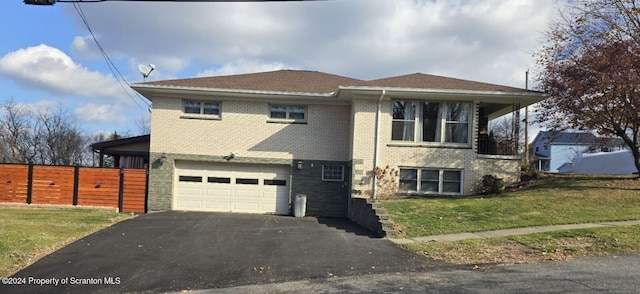 view of front of property with a garage and a front lawn