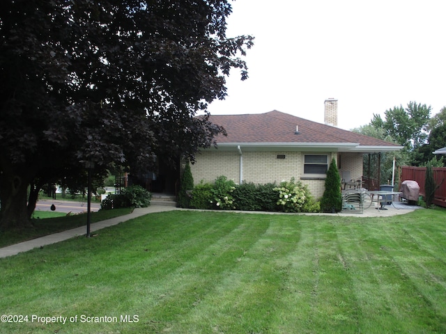 exterior space featuring a patio area and a yard