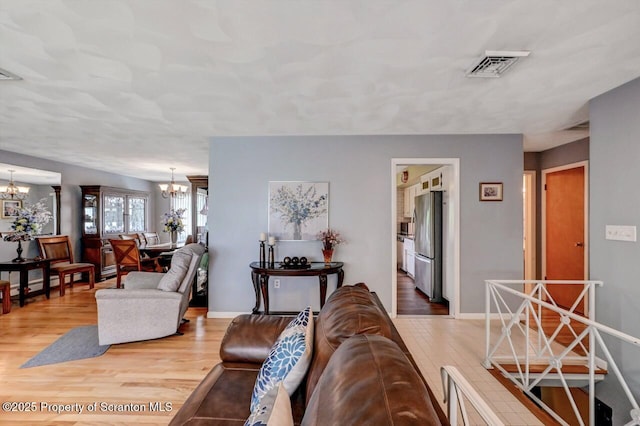 21 Leslie Dr, Scranton, PA 18505 - living area with a chandelier, wood finished floors, and baseboards