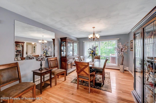 21 Leslie Dr, Scranton, PA 18505 - dining area featuring a chandelier, light wood-style flooring, and a baseboard radiator