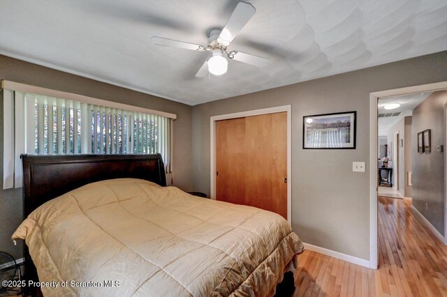 21 Leslie Dr, Scranton, PA 18505 - bedroom with baseboards, hardwood / wood-style flooring, a closet, and ceiling fan