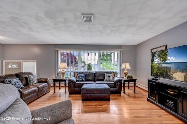 21 Leslie Dr, Scranton, PA 18505 - living room featuring light wood-style floors and a baseboard heating unit