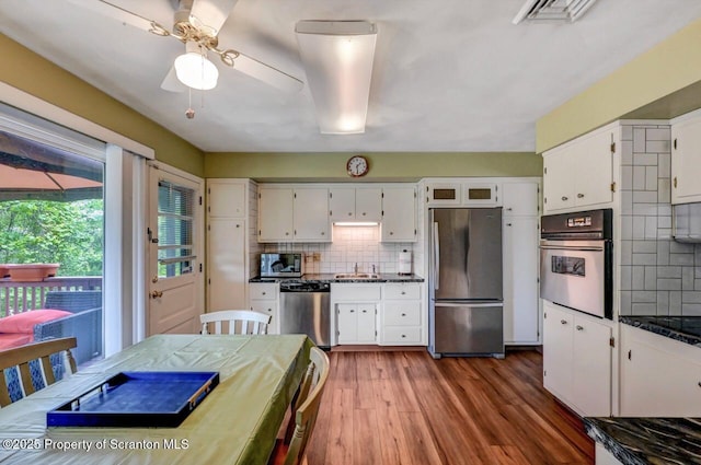 21 Leslie Dr, Scranton, PA 18505 - kitchen with appliances with stainless steel finishes, backsplash, white cabinetry, and wood finished floors