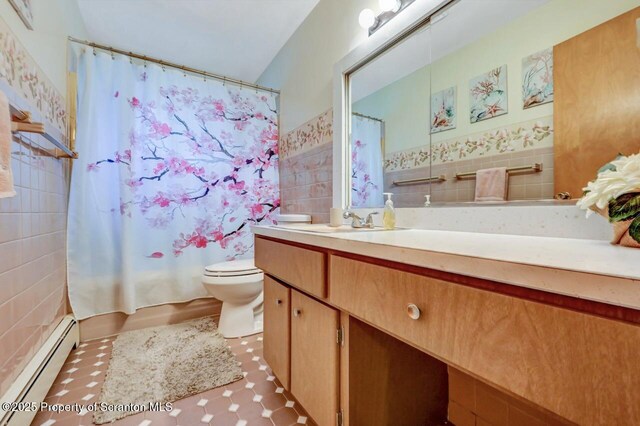 21 Leslie Dr, Scranton, PA 18505 - full bath featuring baseboard heating, tile walls, toilet, vanity, and tile patterned flooring