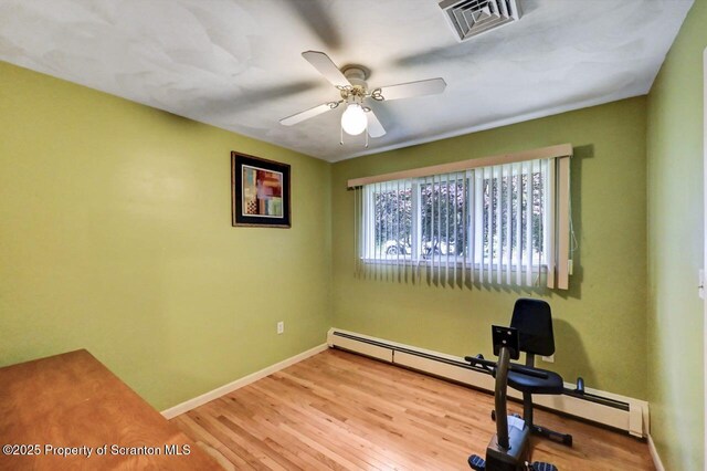 21 Leslie Dr, Scranton, PA 18505 - exercise room with baseboards, a ceiling fan, wood finished floors, and baseboard heating