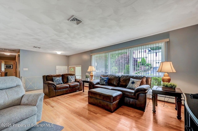 21 Leslie Dr, Scranton, PA 18505 - living area with light wood-style floors and baseboard heating
