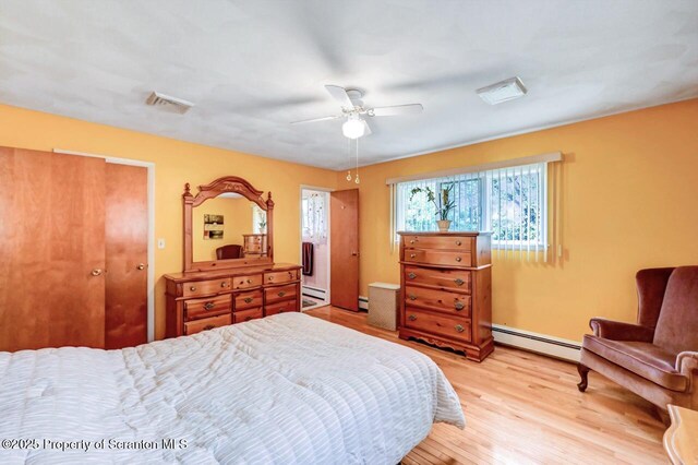 21 Leslie Dr, Scranton, PA 18505 - bedroom with baseboard heating, light wood-style flooring, a baseboard heating unit, and ceiling fan