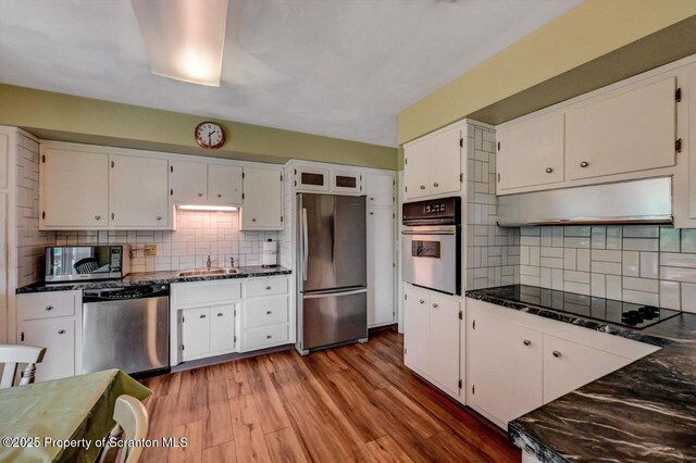 21 Leslie Dr, Scranton, PA 18505 - kitchen with stainless steel appliances, a sink, tasteful backsplash, white cabinetry, and dark stone counters